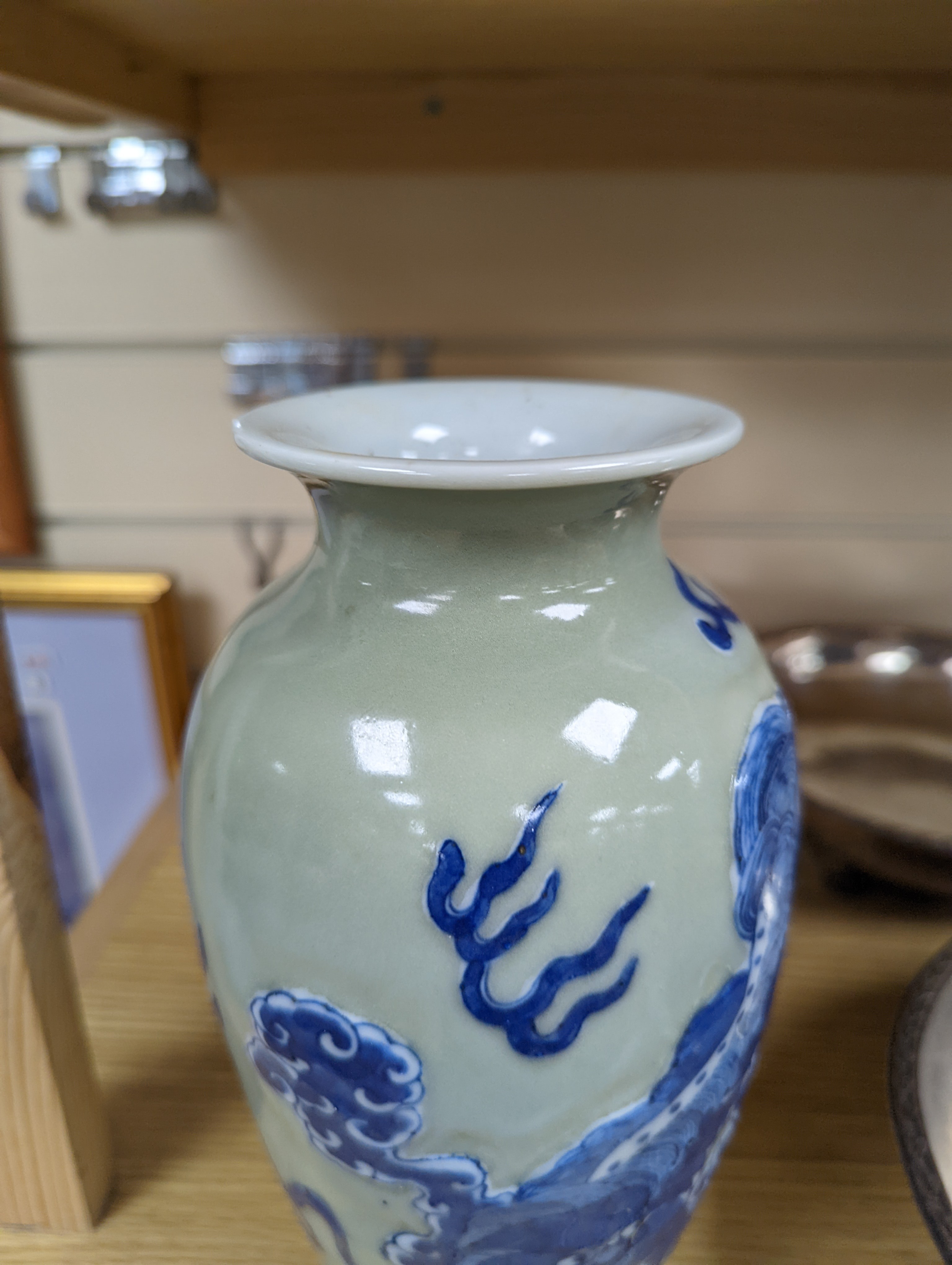 A Chinese celadon glazed vase, 24cm and a Chinese famille rose teapot and matching cream jug, a.f.